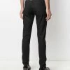 Alexander McQueen Logo studded slim fit jeans 10 Alexander McQueen logo-studded slim-fit jeans