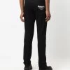 Alexander McQueen Logo print slim cut jeans 10 Alexander McQueen logo-print slim-cut jeans